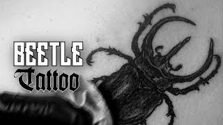 Proceso de tatuado de escarabajo atlas